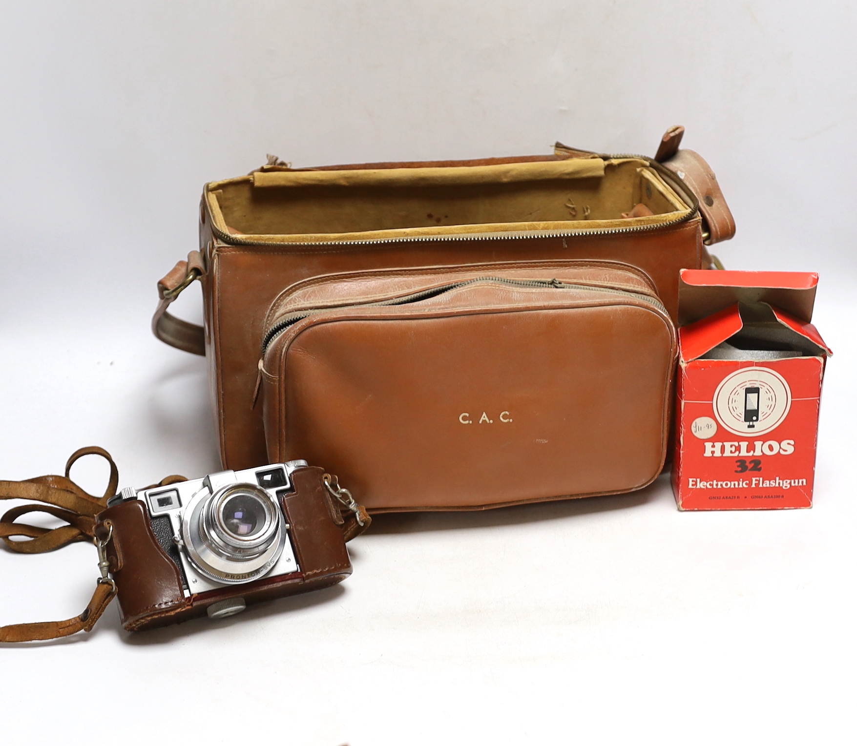 A Lordomat leather cased camera, lenses, flashgun, tripod and larger camera case
